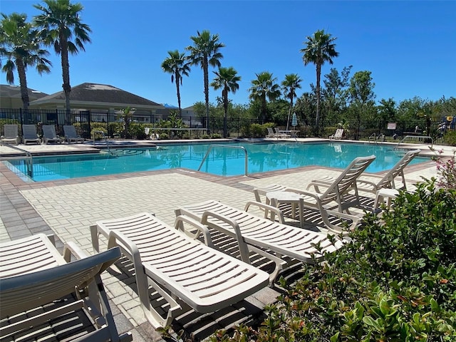 pool featuring a patio area and fence