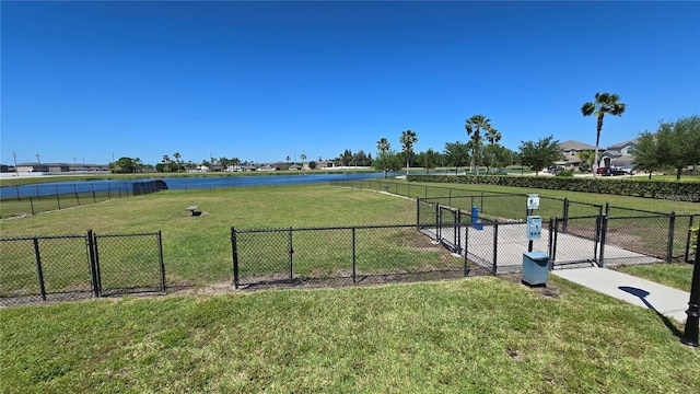 surrounding community featuring a yard, fence, and a gate