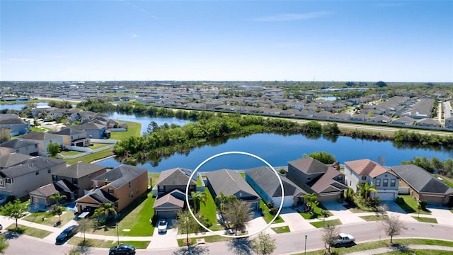 birds eye view of property with a residential view and a water view