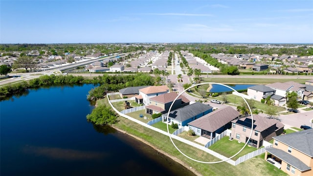 drone / aerial view with a water view and a residential view