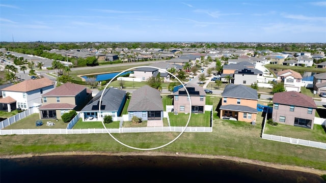 drone / aerial view with a residential view and a water view