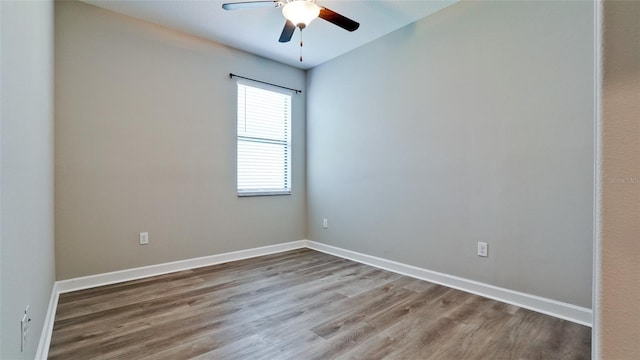 unfurnished room with baseboards, a ceiling fan, and wood finished floors
