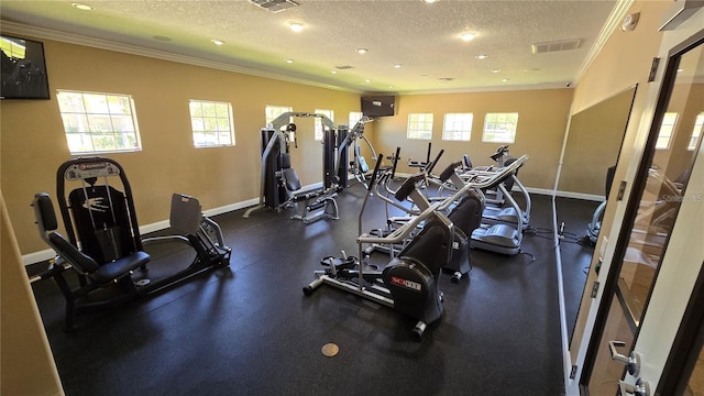 exercise room featuring crown molding, a textured ceiling, and baseboards