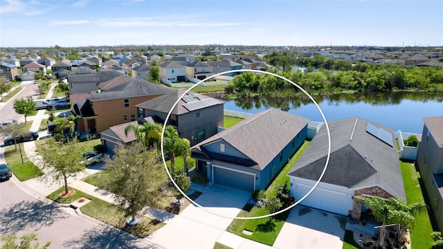 drone / aerial view with a residential view and a water view