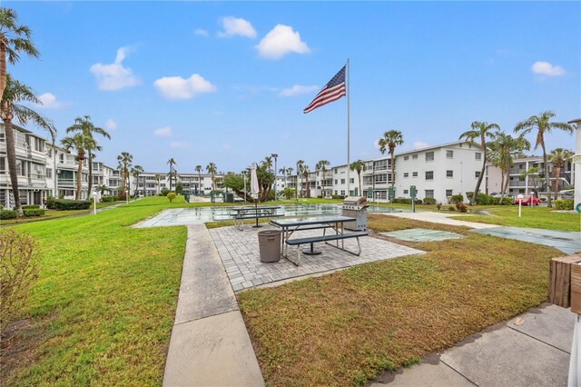 view of property's community with a residential view and a lawn