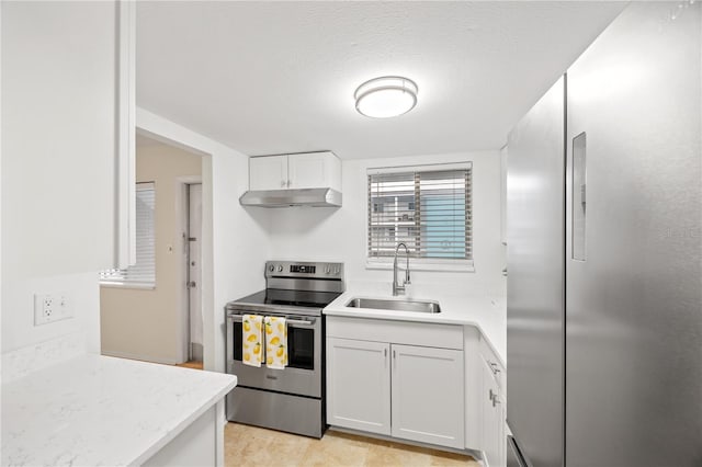 kitchen featuring a sink, white cabinets, stainless steel appliances, and under cabinet range hood