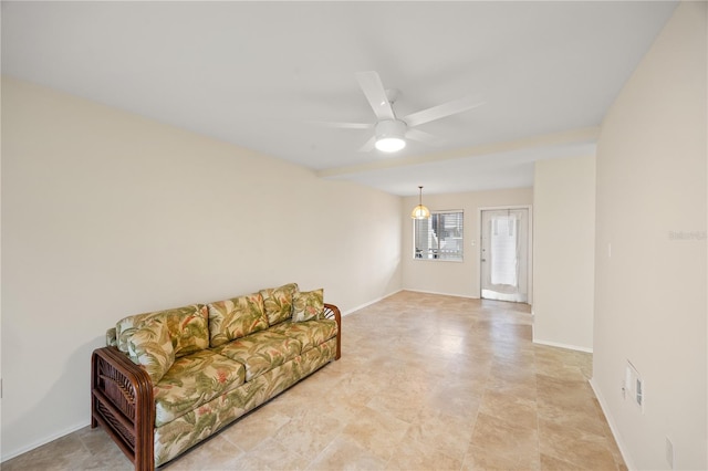 living room with baseboards and ceiling fan