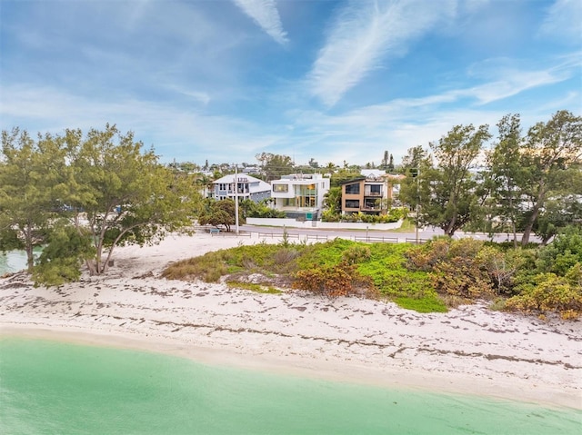 exterior space with a water view and a beach view