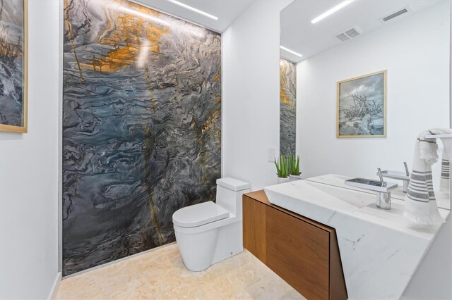 full bathroom with toilet, visible vents, and vanity