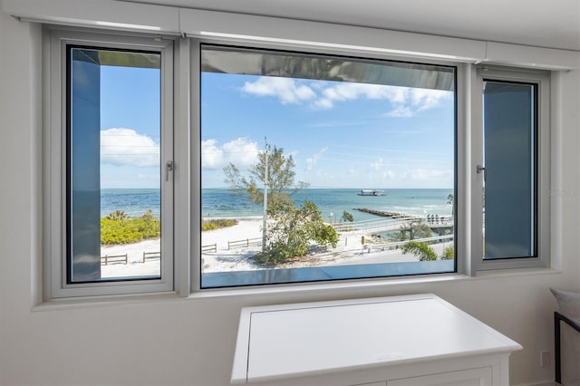 doorway with a water view and a view of the beach