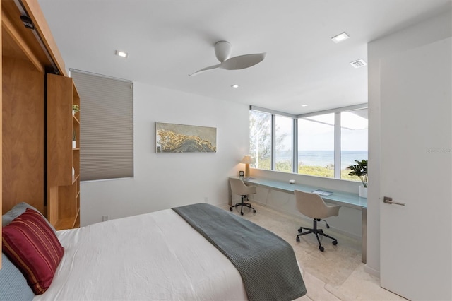 bedroom featuring a water view, built in study area, a ceiling fan, and recessed lighting