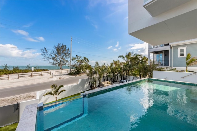 pool featuring a water view and fence