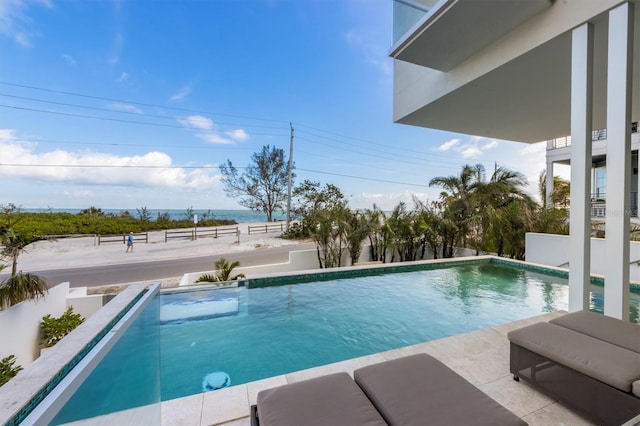 outdoor pool with a water view and a fenced backyard