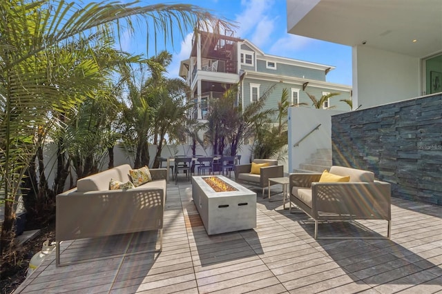 wooden deck with an outdoor living space with a fire pit