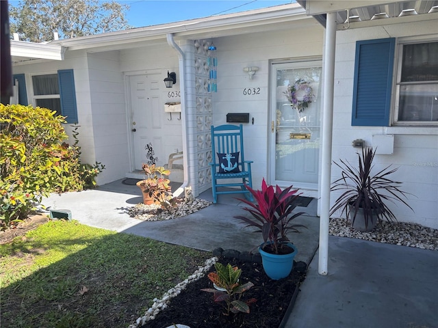 doorway to property featuring concrete block siding