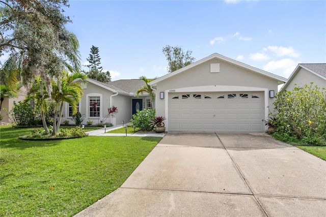 single story home featuring an attached garage, a front yard, concrete driveway, and stucco siding