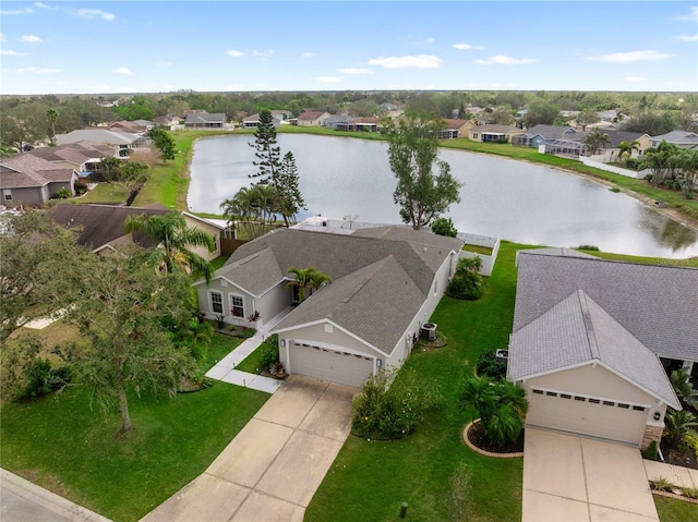 drone / aerial view with a residential view and a water view