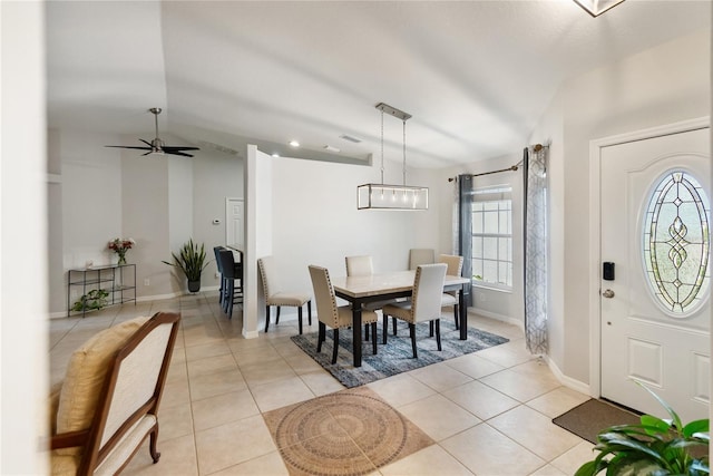 foyer with vaulted ceiling, ceiling fan, light tile patterned flooring, and baseboards