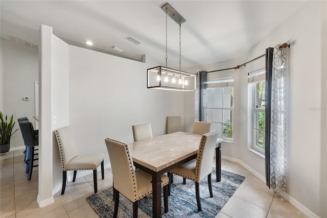 dining area featuring light tile patterned floors, visible vents, and baseboards