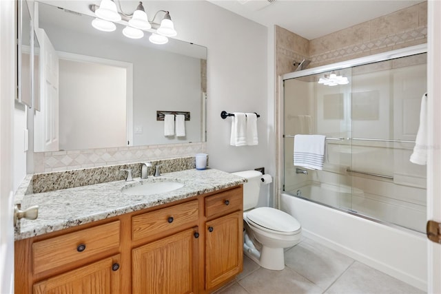 full bathroom featuring bath / shower combo with glass door, decorative backsplash, toilet, tile patterned flooring, and vanity