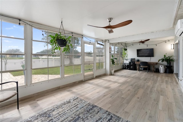 sunroom featuring a ceiling fan and a wealth of natural light