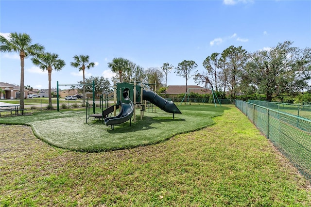 community play area featuring a yard and fence