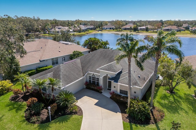 drone / aerial view featuring a residential view and a water view