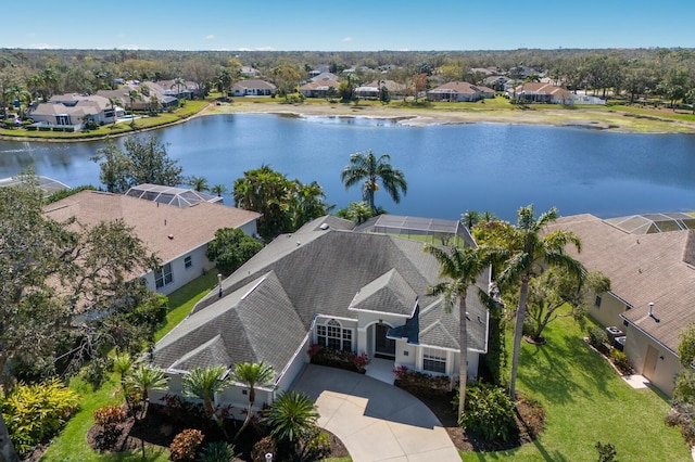 drone / aerial view featuring a water view and a residential view