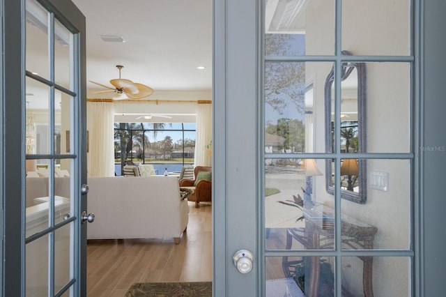 entryway featuring visible vents, a ceiling fan, wood finished floors, and french doors