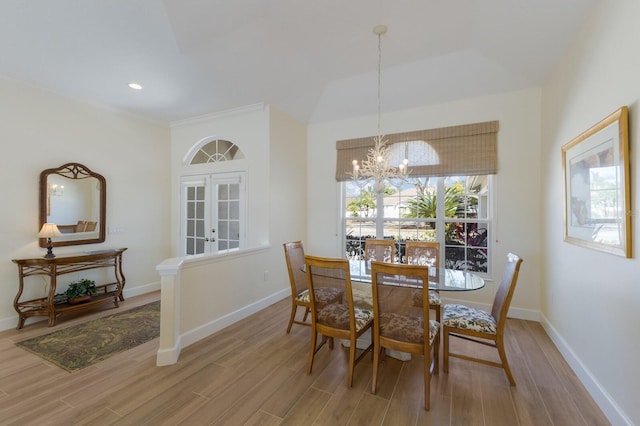 dining space featuring french doors, a notable chandelier, recessed lighting, wood finished floors, and baseboards