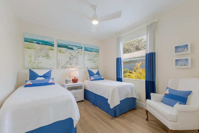 bedroom featuring light wood finished floors, ceiling fan, and baseboards