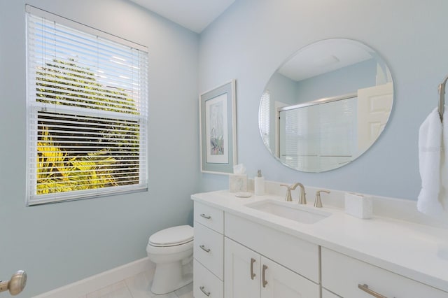 full bath featuring toilet, a stall shower, vanity, and a healthy amount of sunlight