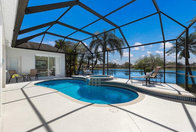 view of pool featuring a pool with connected hot tub, glass enclosure, a patio, and a water view