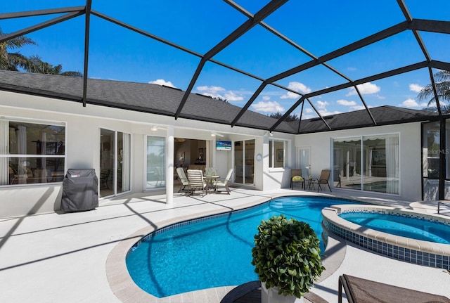 view of swimming pool with a patio area, a lanai, and a pool with connected hot tub