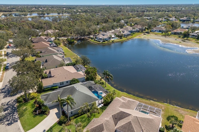 drone / aerial view featuring a residential view and a water view