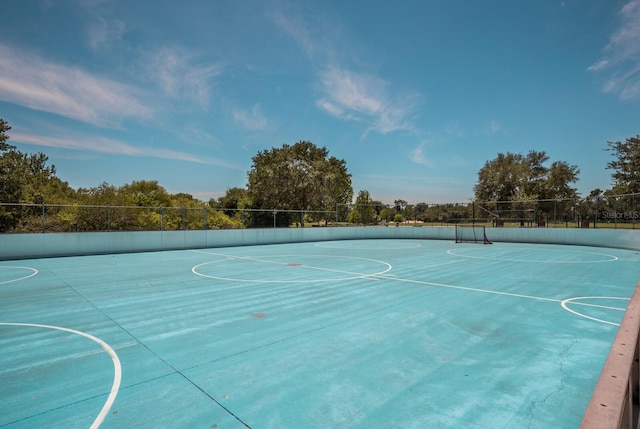 view of sport court featuring fence