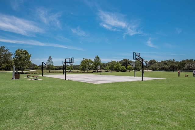 view of sport court featuring community basketball court and a lawn