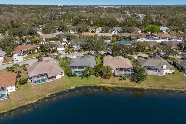 drone / aerial view featuring a water view and a residential view