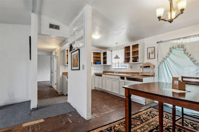 kitchen with visible vents, glass insert cabinets, hanging light fixtures, white cabinetry, and open shelves