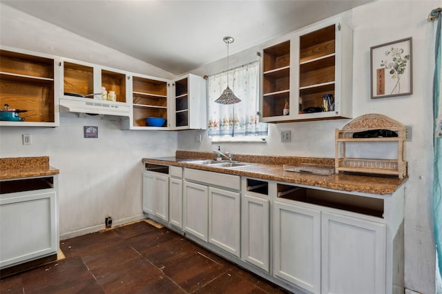 kitchen with lofted ceiling, a sink, white cabinetry, open shelves, and pendant lighting