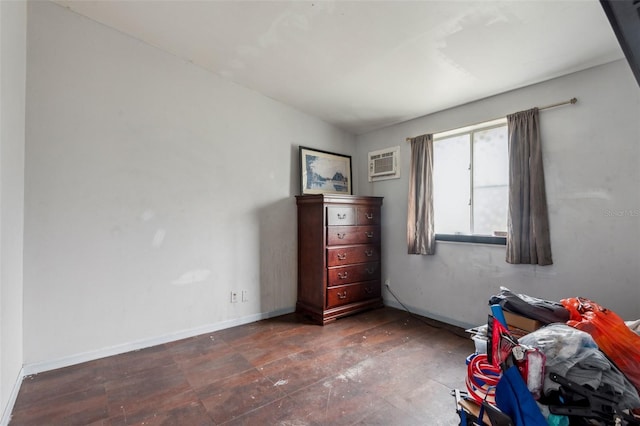 unfurnished bedroom with baseboards and a wall mounted AC