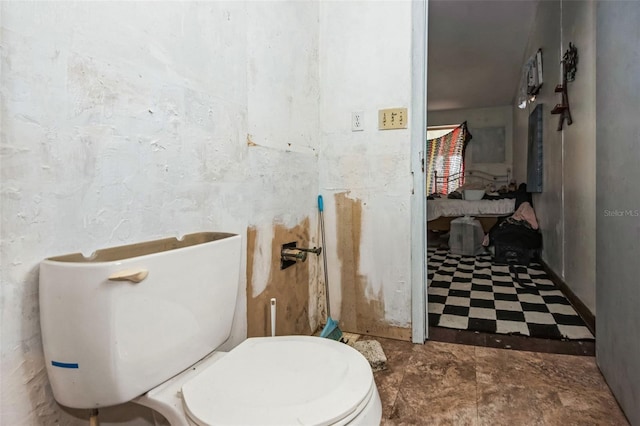 bathroom with toilet and tile patterned floors