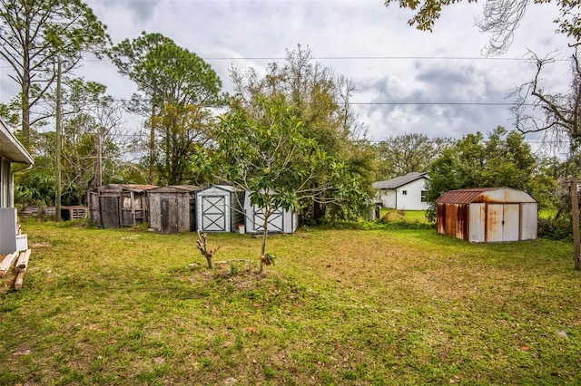 view of yard featuring a storage shed and an outbuilding