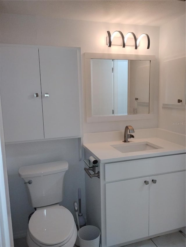 bathroom with toilet and vanity