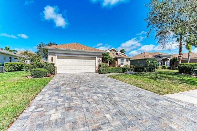 single story home featuring a garage, a front lawn, decorative driveway, and stucco siding