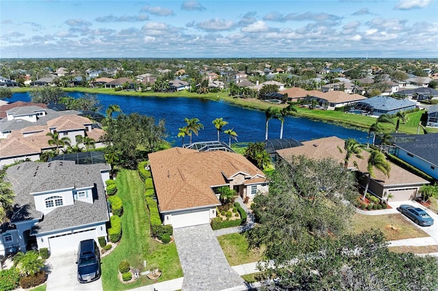 birds eye view of property with a water view and a residential view