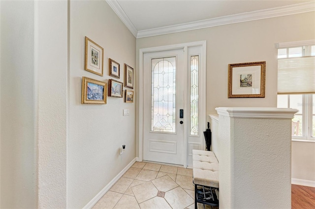 foyer entrance with ornamental molding, baseboards, and light tile patterned floors