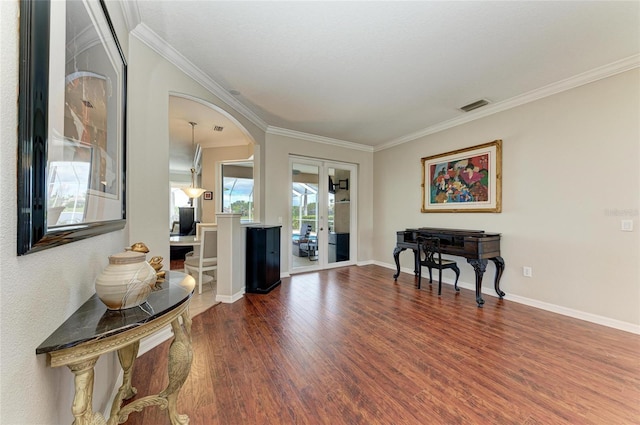 foyer entrance with dark wood-type flooring, visible vents, baseboards, ornamental molding, and french doors