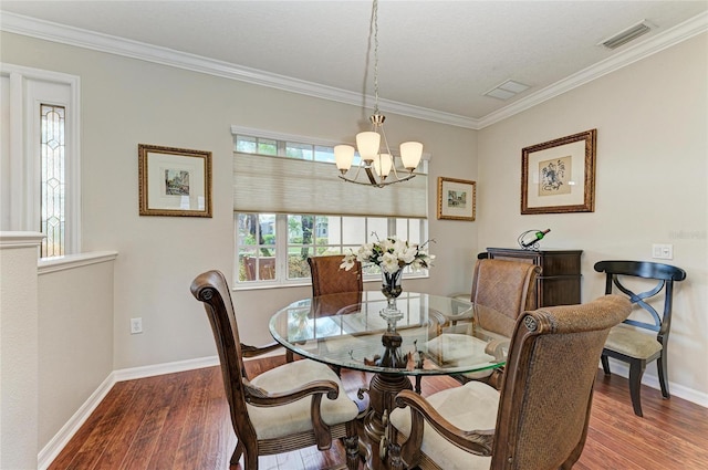 dining space featuring crown molding, wood finished floors, visible vents, and baseboards