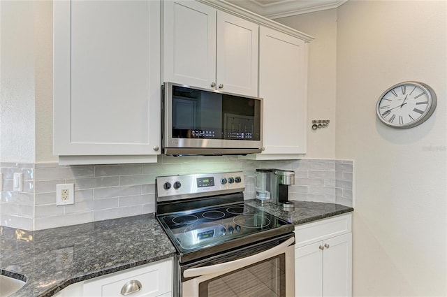 kitchen featuring white cabinetry, appliances with stainless steel finishes, and backsplash